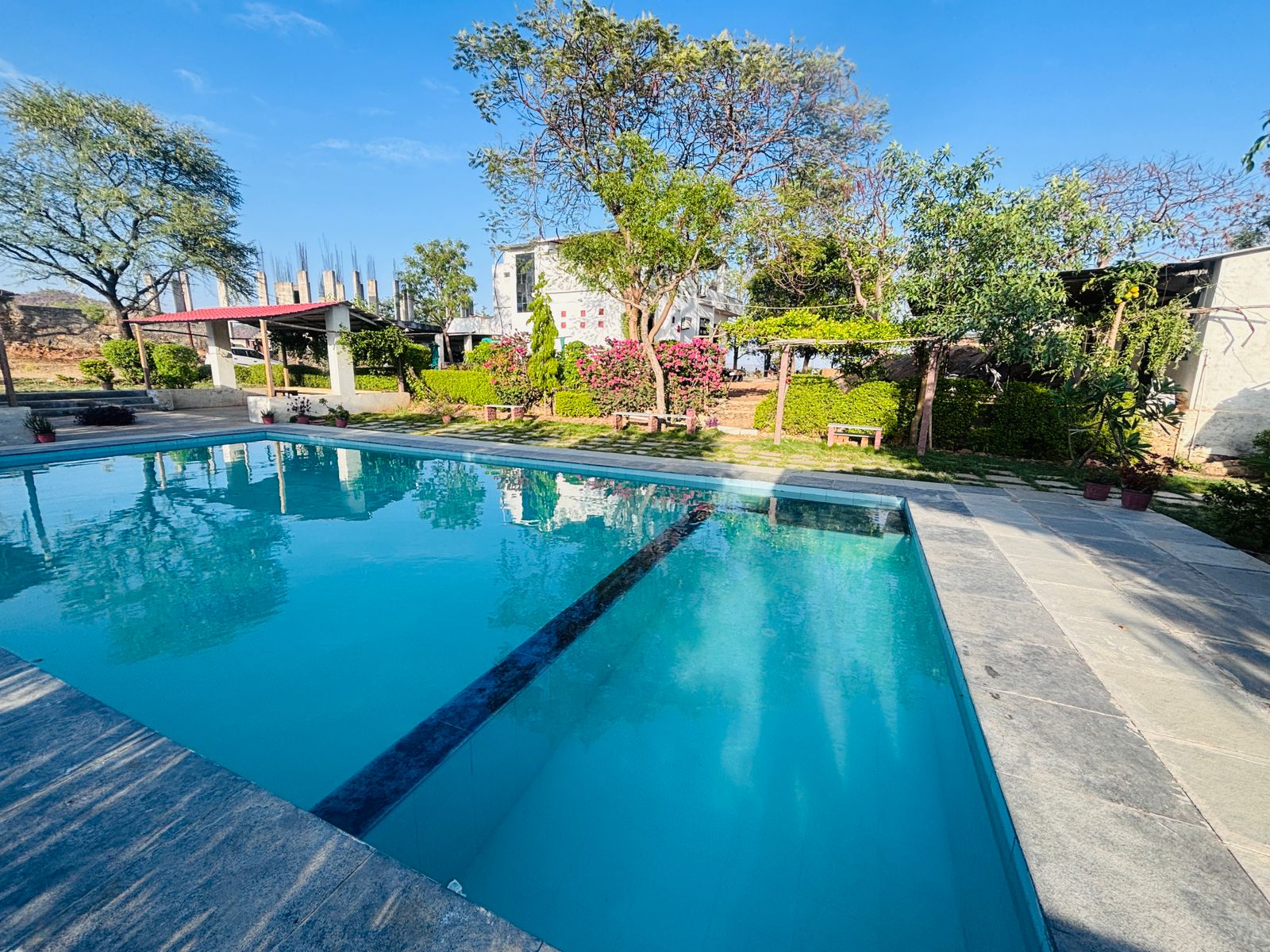 Pool with garden and flower beds