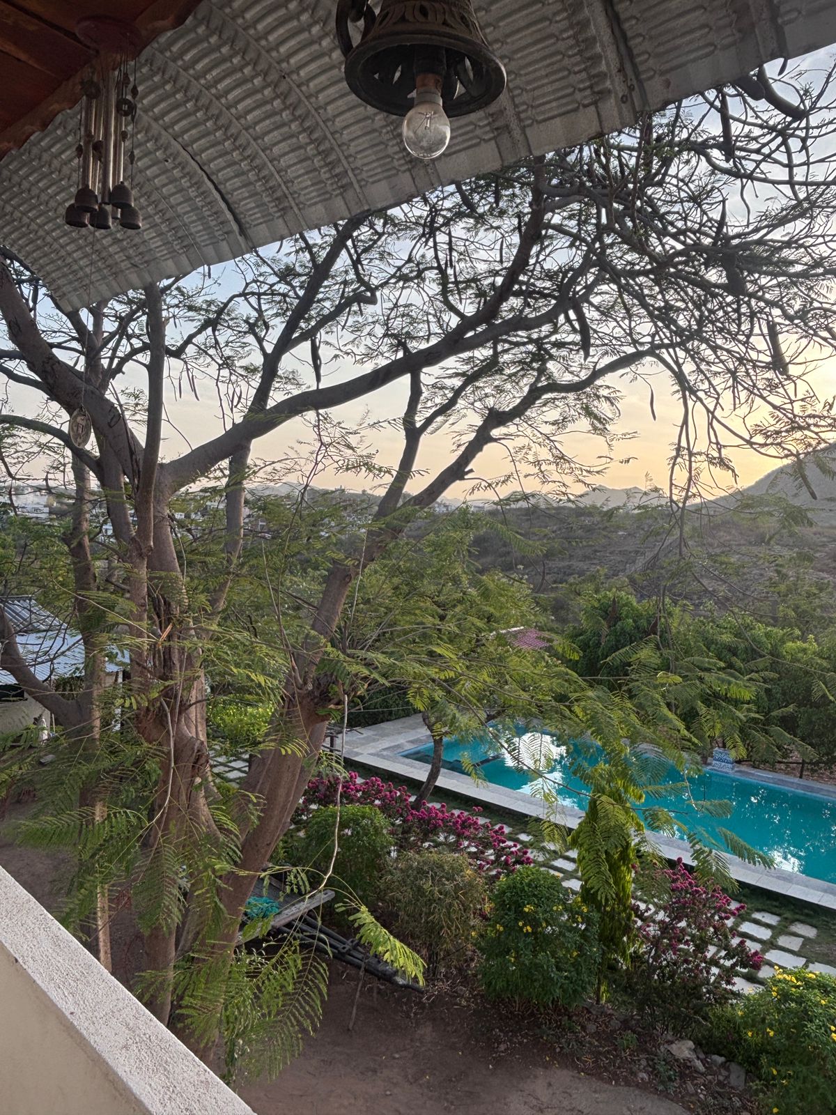 Villa balcony view over trees and pool